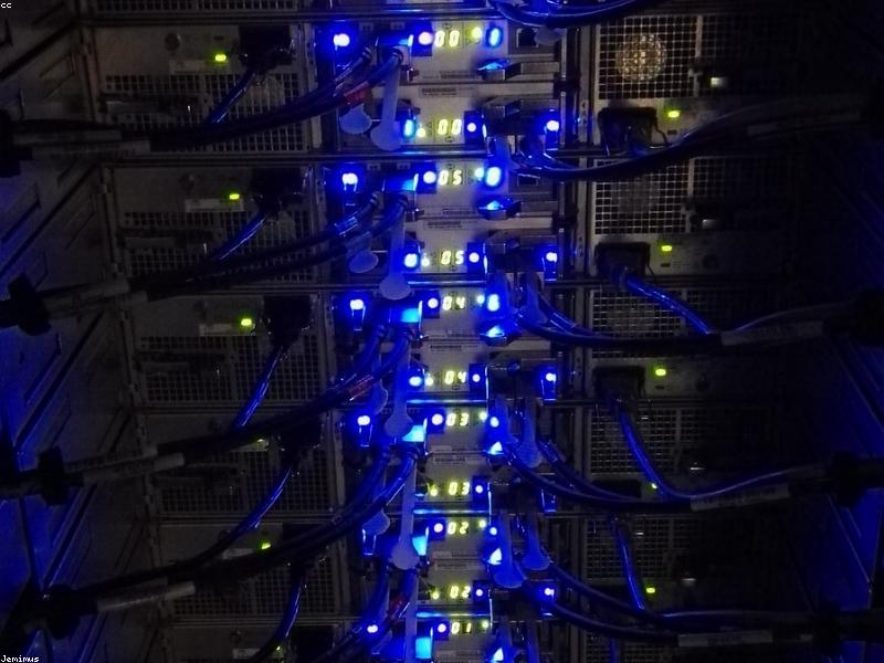 Futuristic server room with blue LED lighting and sleek data racks